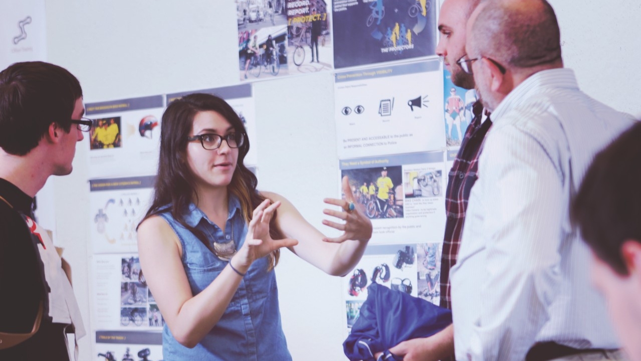 Student explaining concept to other students