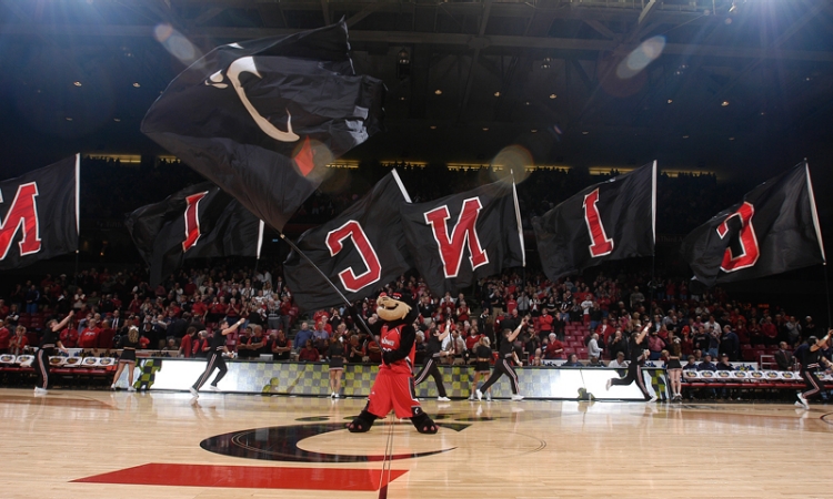 Bearcat mascot waves flag at basketball game
