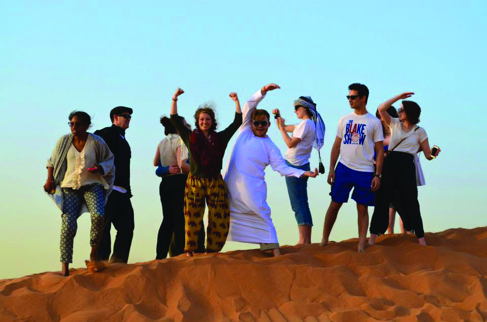 Students Holding Arms in UC Formation on Study Abroad Trip